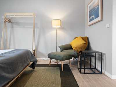 armchair and footstool in a corner of the master bedroom